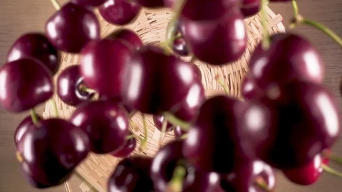 Slow motion cherry falls down into a wicker basket Stock Footage 90488042