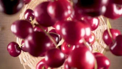 Slow motion cherry falls down into a wicker basket Video stock 90488135