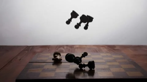 Slow motion Chess pieces fall on the chessboard and scatter on it. The game is o Stock Footage 233031502