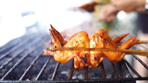 Slow motion of chicken wing grilled on charcoal stove with smoke Stock Footage 111503428