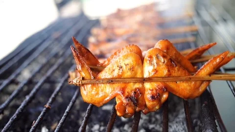 Slow motion of chicken wing grilled on charcoal stove with smoke Stock Footage 111503437