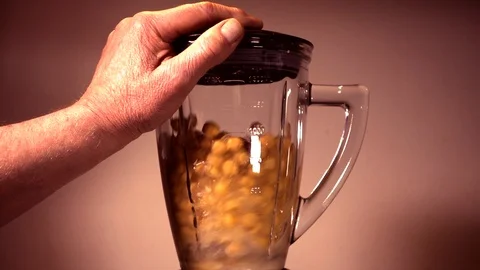 Slow motion: Chickpeas and tomatoes in a blender. Stock Footage 87219979