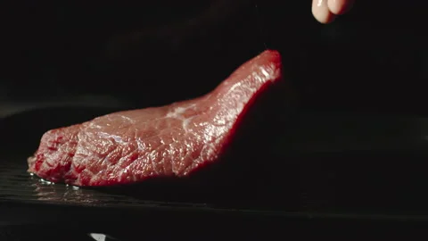 SLOW MOTION: A Chief Puts A Big Beef Steak On A Grill Видео 161688162
