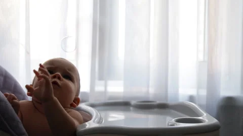 Slow motion of a child catches a bubble. Stock Footage 92201259