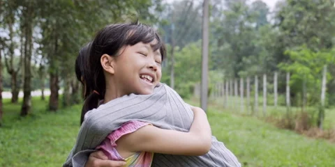 Slow motion child jumping hugging Stock Footage 162113766