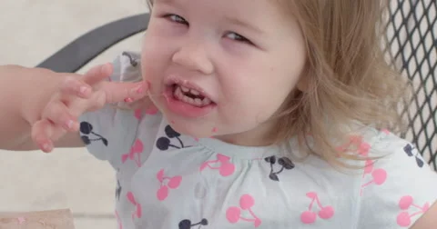 Slow Motion Child Licks Sweets of of Finger and Smiles Stock Footage 61468518