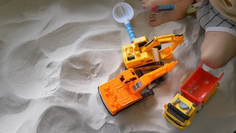Slow motion, child playing construction toy in sand playground Stock Footage 94662184