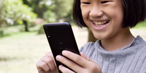 Slow motion child smile use smartohone Stock Footage 162116065