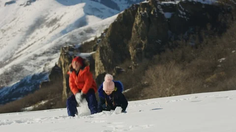 Slow motion of children playing and throwing snow near mountain / South Fork, Stock Footage 106944881