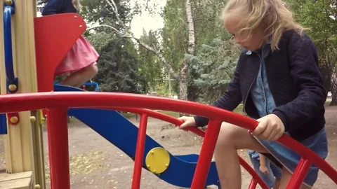 Slow motion. Children playing on playground in autumn Stockbeeldmateriaal 79469028