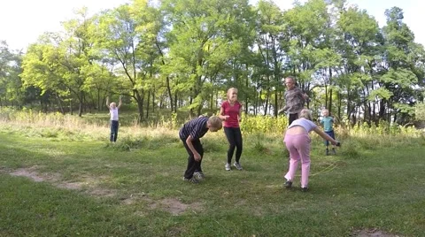 Slow motion. children playing school jumping rope in a city park with Video stock 54635544