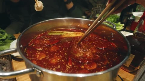 Slow Motion Chinese Hot Pot Gathering: Friends and Family Dipping Meat with Stock Footage 342244139