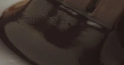 Slow Motion Chocolate Bar Falling into Liquid Chocolate - Rich Dessert Footage Video stock 276875284