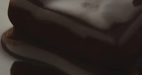 Slow Motion Chocolate Bar Falling into Liquid Chocolate - Rich Dessert Footage Stock Footage 276875293