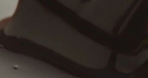 Slow Motion Chocolate Bar Falling into Liquid Chocolate - Rich Dessert Footage Video stock 276875301