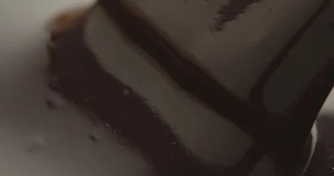 Slow Motion Chocolate Bar Falling into Liquid Chocolate - Rich Dessert Footage Stock Footage 276875331