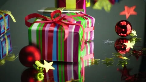 Slow Motion Christmas Gift Boxes an Stars Falls on theTable Stock Footage 58321043