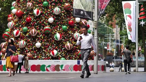 Slow motion Christmas tree and commuters in Martin Place Sydney 4K Stock Footage 166544120