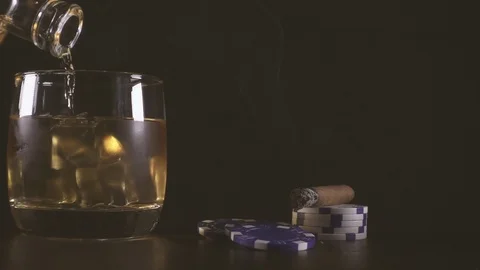 Slow motion cigar and playing chips and a glass of whiskey Stock Footage 92430192