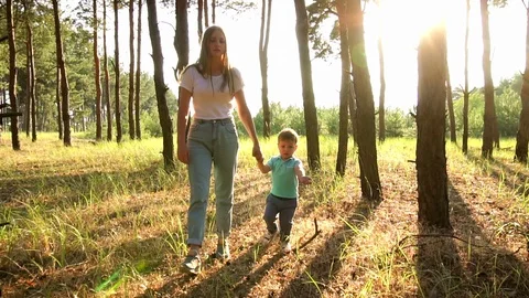 Slow motion cinematic view on young sister holding adorable little brother hand Stock Footage 104371274