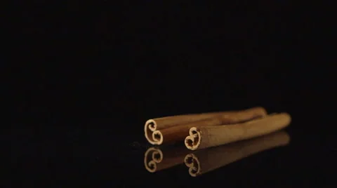 SLOW MOTION: A cinnamon stick falls on a black desk Stock Footage 61033534