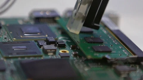 Slow Motion of circuit board being assembled with automated robotic arm.-Dan Stock Footage 120185400