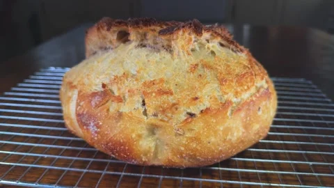 Slow motion circular dolly shot of a freshly baked crusty bread loaf. Stock-Footage 292651841