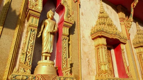 Slow motion circular reveal Buddhist Statue on Temple wall Stock Footage 56340202