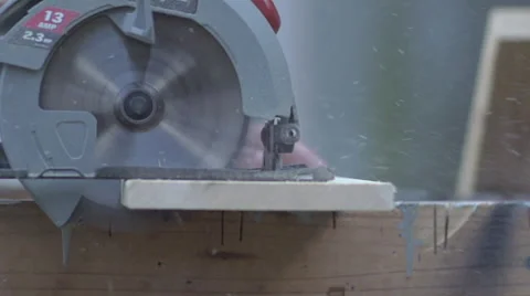 Slow Motion Circular saw cuts through board - side angle Video stock 68338305