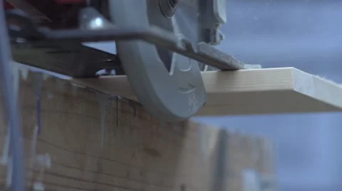 Slow Motion Circular saw cuts through board Video stock 68339713