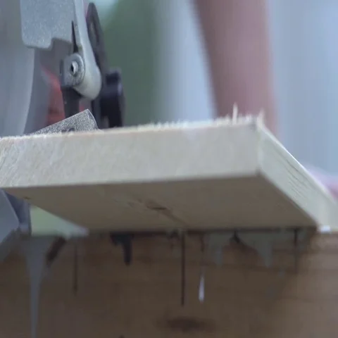 Slow Motion Circular saw cuts through board - Low POV Video stock 69541584