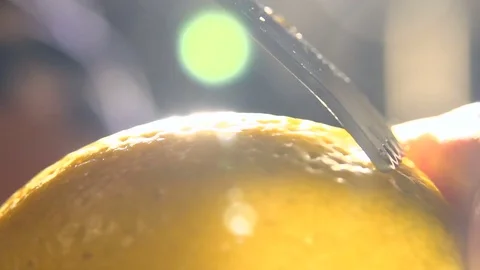 Slow motion citrus zester on lemon skin, twirls of zest falling against. macro Stock-Footage 76431361