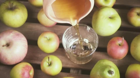 Slow motion from a clay jug pouring juice into a glass Stock Footage 88098105