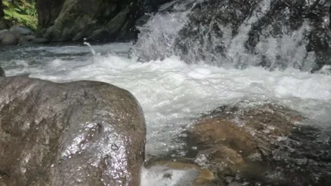 Slow motion of a clear mountain river flowing through a rocky cascade Stock Footage 321265005