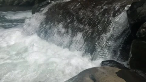 Slow motion of a clear mountain river flowing through a rocky cascade Stock Footage 321265006