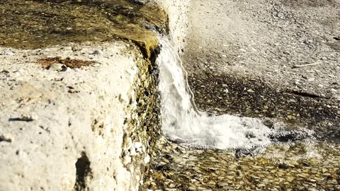 Slow motion of clear transparent fresh water flowing down from the rocks Stock Footage 74491506