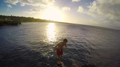 Slow Motion Cliff Jumping Backflip at Sunset. Athletic Young Man Jumping From Stock Footage 57223833