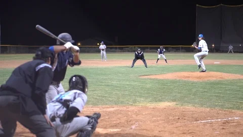 Slow motion clip of a batter hitting a pop fly in a minor league baseball Stock Footage 123082789