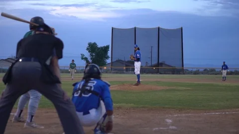 Slow motion clip during minor league baseball game from behind home plate Stock Footage 123082810