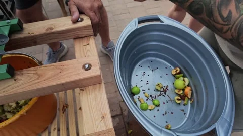 Slow Motion Clip of Men Preparing Apple Pulp for Pressing Today Stock Footage 346688562
