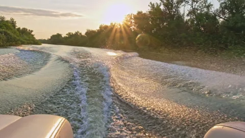 Slow-motion clip: The motorboat creates beautiful waves, splashes from the ru Stock Footage 166182031
