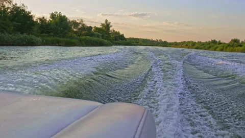 Slow-motion clip: The motorboat creates beautiful waves, splashes from the ru Stock Footage 219933762