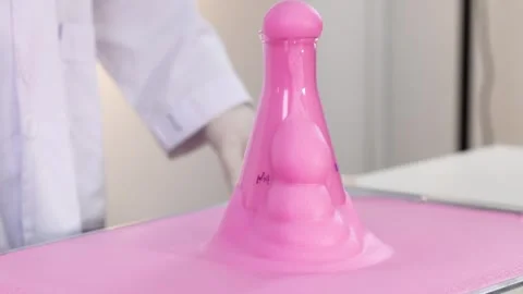 Slow motion clip of pink foam erupting from chemistry flask in laboratory s.. Stock Footage 333466642