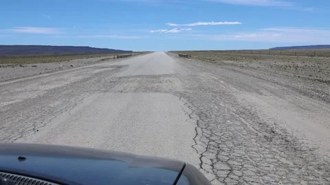 Slow-motion clip showing a car driving along a potholed highway Stock Footage 345664872