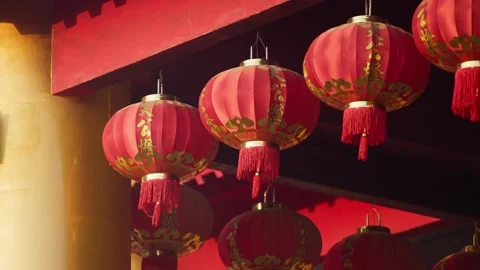 Slow motion clip showing vibrant red lanterns hanging above temple entrance Stock Footage 312278575