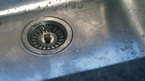 A slow motion clip of water running from a tap into a sink Stock Footage 87857199
