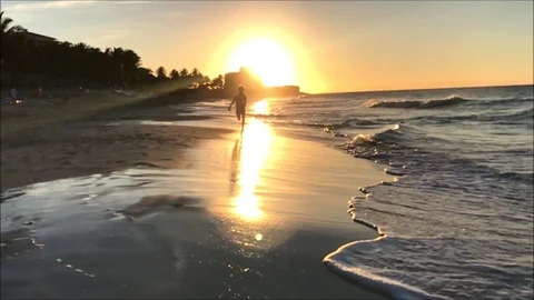 Slow motion clip of a young boy running on a beach Stock Footage 104126324