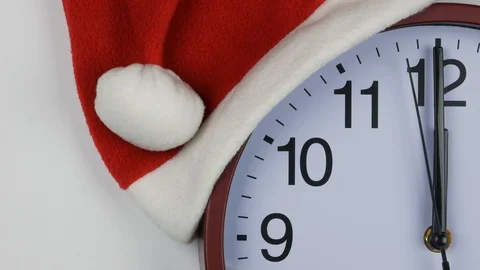 Slow motion of a clock in a santa hat showing midnight Stock-Footage 99516955