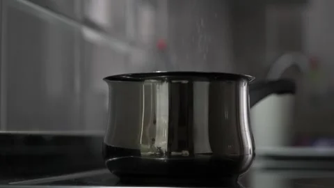 Slow motion close up adding salt in boiling water. Stock Footage 339805931
