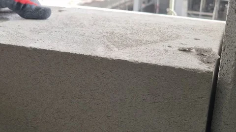 Slow Motion Close-up of Adjusting Concrete Block with Rubber Mallet Stock Footage 334334905